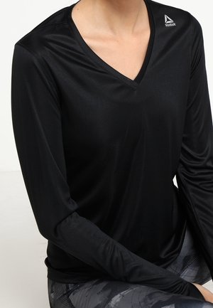 Schwarz, langärmliges Sportshirt mit V-Ausschnitt, hergestellt aus glattem, dehnbarem Material. Verfügt über ein kleines Reebok-Logo auf der linken Schulter.