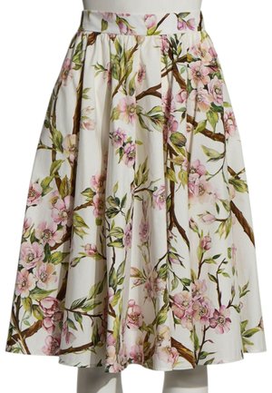 Witte geplooide rok met roze kersenbloesem en groene bladeren bloemenprint op takken.