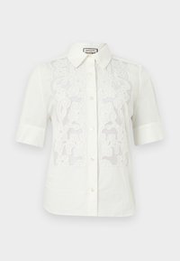 Λευκό πουκάμισο με κοντά μανίκια και κουμπιά, με μυτερό γιακά και εμπρός τμήματα από δαντέλα με λουλουδένιο σχέδιο.