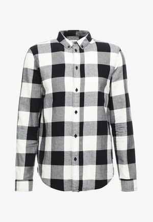 Black and white checkered long-sleeve shirt with button closure, featuring a classic collar and contrasting square patterns. Cotton material.