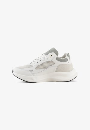White athletic sneaker featuring a mix of mesh and suede materials, smooth rounded shape, and a thick rubber sole with minimal design details.