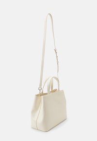Cremfarbene Lederhandtasche mit strukturierter Form, doppelten Obergriffen und einem verstellbaren Schulterriemen. Glatte Textur und minimalistisches Design.