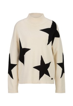 Pull à col montant couleur crème avec grands motifs d'étoiles noires sur le devant et les manches, col côtelé et manches longues.