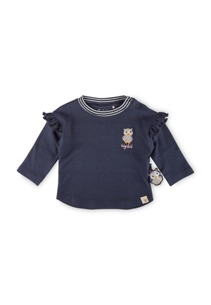 Marineblaues Langarmshirt mit Rüschensleeves, gestreiftem Kragen, Eulenstickerei und einem dekorativen Etikett mit Eulendesign. Aus weichem Baumwollmaterial.