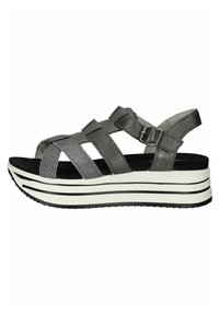 Gray platform sandals with wide, crisscross straps. Made of textured material, featuring a black and white striped sole with subtle sheen.