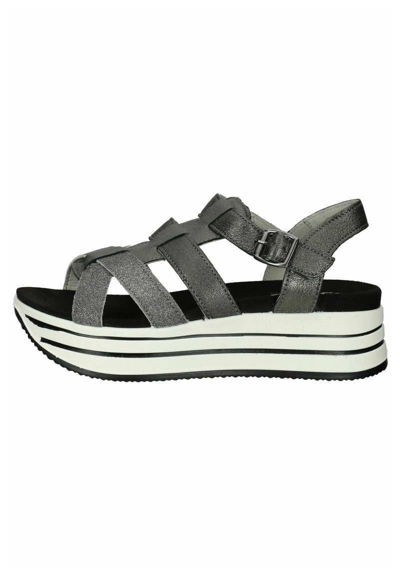 Gray platform sandals with wide, crisscross straps. Made of textured material, featuring a black and white striped sole with subtle sheen.