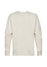Langsleeve shirt in off-white, gemaakt van zachte katoen. Beschikt over een ronde hals en een eenvoudige, onversierde achterkant zonder zichtbare accenten.