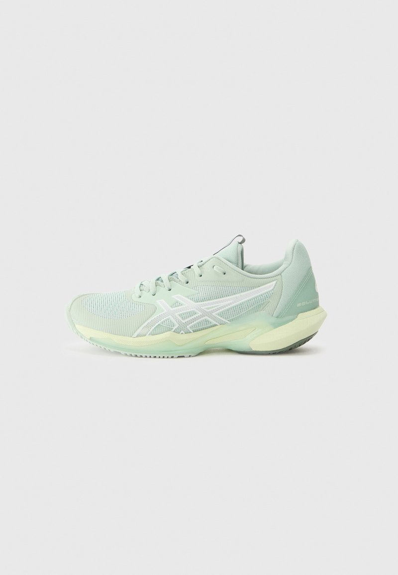 Light green athletic shoes with mesh upper, white accents, padded collar, and rubber sole. Features a sleek design and flexible cushioning.