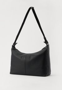 Black leather shoulder bag with a smooth texture, curved shape, and adjustable strap. Features a zip closure and minimalistic design.