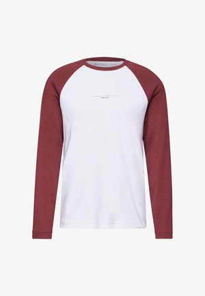 Maglietta a maniche lunghe con corpo bianco e maniche raglan bordeaux. Presenta un semplice design stampato al centro. Materiale in cotone morbido.