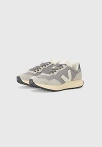 Sporty sneakers featuring a grey mesh upper, suede accents, cream midsole, black rubber outsole, and a distinct logo on the side.