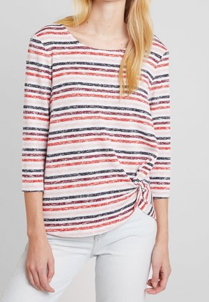 Gestreiftes Langarmshirt in Weiß, Rot und Marineblau. Weicher Stoff mit einem Knoten-Detail an der Seite, Rundhalsausschnitt und Dreiviertelärmeln.