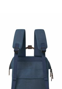 Navy blue backpack with padded shoulder straps, adjustable clips, and a zipper. Sturdy fabric with a smooth texture and minimalistic design.