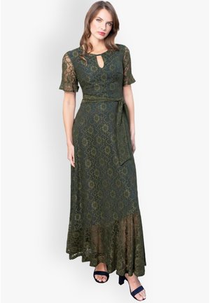 Abito maxi verde in pizzo con maniche corte, scollatura a oblò, una cintura con nodo in vita e un orlo a strati. Presenta un motivo floreale.