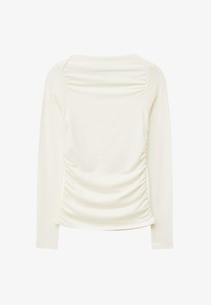 Long-sleeve top in cream with gathered texture on the back, featuring a rounded neckline and smooth fabric. No visible hardware or patterns.