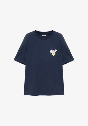 T-shirt bleu marine à manches courtes avec col rond et petit texte blanc ainsi qu’un motif fleur jaune sur la poitrine gauche.