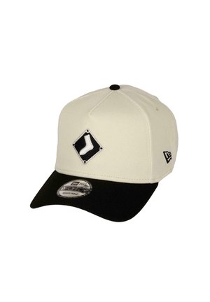 White baseball cap with a black visor, featuring a diamond-shaped patch with a white sock design and an adjustable back.