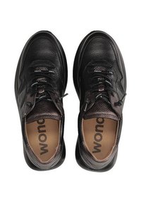 Czarne skórzane trampki z teksturowanymi akcentami, sznurowadłami i wyściełanym językiem. Wyposażone w amortyzowane wkładki z widocznym logo "wondo" w środku.
