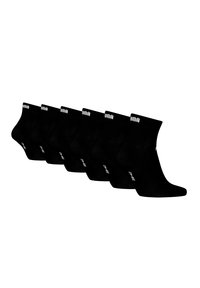 Schwarze Knöchelsocken aus einem weichen Stoff, mit einem gerippten Bund und weißem Logo, in einer Reihe angeordnet mit einer glatten Textur.