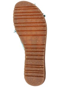 Kumipohjainen kengänpohja teksturoidulla, segmentoituilla kuvioilla. Väri on ruskea oranssilla sävyllä, ja siinä on uria pitävyyttä ja pitoa varten.