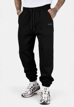 JOGGER ESSENTIAL - Tracksuit bottoms - black