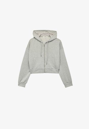 Grijze cropped hoodie gemaakt van zachte stof. Voorzien van een ritssluiting aan de voorkant, een capuchon met trekkoord en zijzakken. Geribde boorden en zoom.