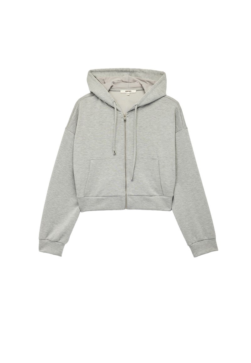 Grå cropped hoodie lavet af blødt stof. Har en frontlynlås, snor i hætten og sidelommer. Ribbet ved håndled og i kanten.