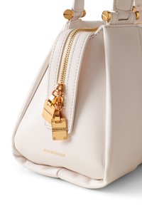 White leather handbag with a square shape, featuring a gold zipper and locks, and embossed logo. Smooth texture and minimalistic design.