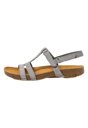 Grå damesandal med justerbare remme og brun polstret sål, sideudsigt på hvid baggrund.