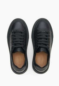 Black leather sneakers with rounded toe, lace-up front, textured side panels, and a contrasting tan insole. Smooth material with minimal detailing.