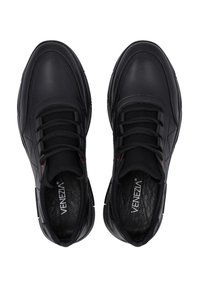 Schwarze Leder-Sneaker mit glatter Textur, runder Spitze, gepolstertem Schaft und schwarzen Schnürsenkeln. Rutschfeste Gummisohle mit roten Akzenten.