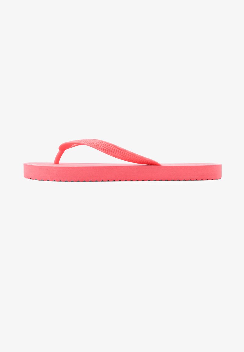 Pink rubber flip-flop with a textured strap, flat sole, and serrated edge. Lightweight design suitable for casual wear.