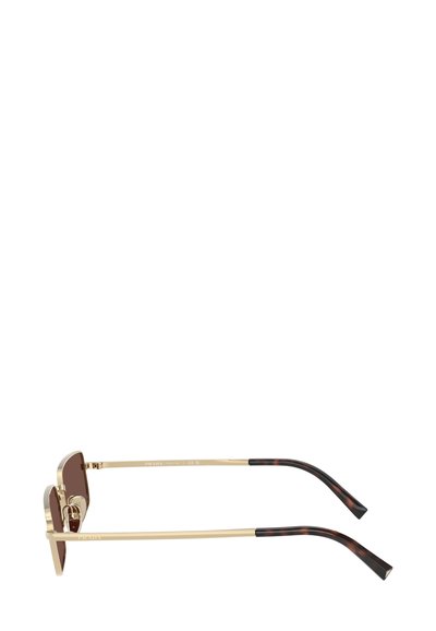Occhiali da sole marroni con montatura in metallo dorato, lenti con tonalità marrone e dettagli in tartaruga scura sulle aste.