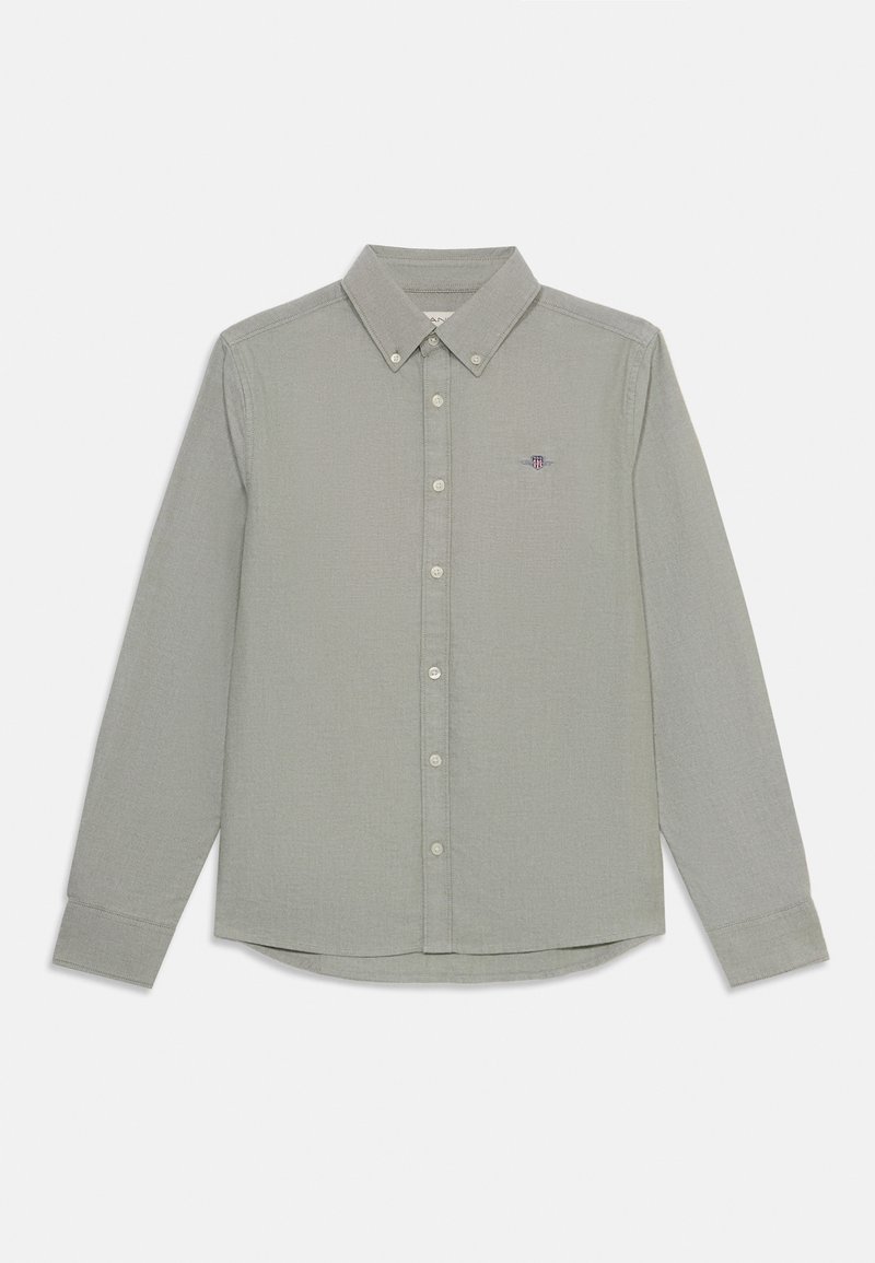 Camisa de manga larga verde claro con cuello abotonado y botones en la parte delantera; cuenta con un logo bordado en el lado izquierdo del pecho. Tejido texturizado.