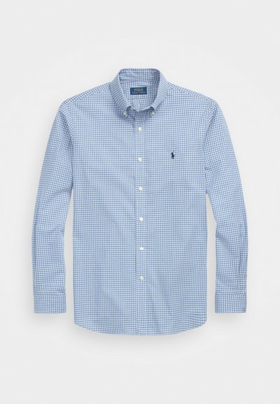 Camisa abotoada com padrão xadrez azul e branco, mangas longas e colarinho clássico. Apresenta um pequeno logotipo no peito.