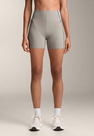 High-waisted, light gray athletic shorts with teal side stripes, made from a smooth, stretchy material. Features a fitted design and mid-thigh length.