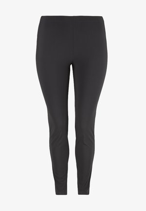 Schwarze Leggings aus dehnbarem, glattem Material. Sie verfügen über ein tailliertes Design mit einem hohen Bund, der sich bis zu den Knöcheln verjüngt.