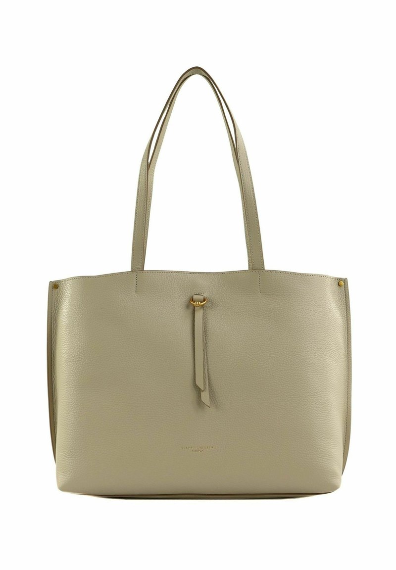 Sac fourre-tout en cuir beige clair avec doubles anses, surface texturée, détail de pampille central et design minimaliste. Pas de quincaillerie visible.