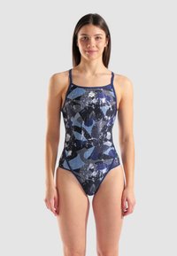 Maillot de bain une pièce en marine et bleu avec des motifs abstraits. Fabriqué en tissu lisse et extensible, avec des bretelles fines et ajustables et un décolleté en forme de scoop.