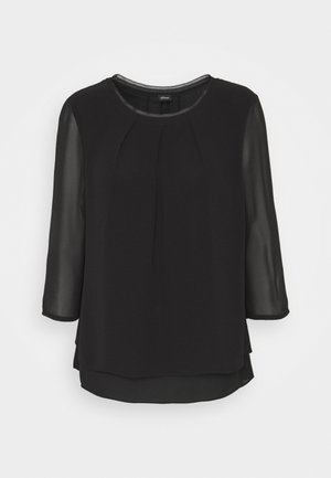 Top negro con un escote redondo, mangas transparentes de tres cuartos, un frente plisado y un diseño de dobladillo en capas.