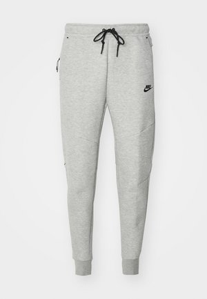 Pantalons de survêtement gris avec une texture lisse, taille élastique, cordon noir ajustable, deux poches latérales et un petit logo noir.
