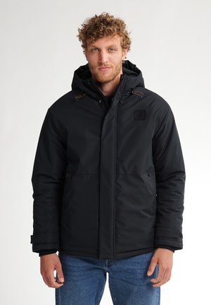 Black insulated jacket with a hood, featuring a zippered front, side pockets, and leather accents on the hood drawstrings.