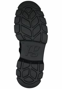 Suela de zapato de goma negra con un patrón de relieve texturizado que presenta surcos curvados y un logo embosado circular.