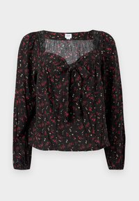 Μαύρο μπλουζάκι με λουλουδάτο σχέδιο και μακριά μανίκια, με δέσιμο μπροστά, πιέτες και μικρά κόκκινα και άσπρα λουλούδια σε όλη την επιφάνεια.