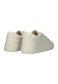 Cream sneakers with a smooth leather upper, rounded toe, and a flat rubber sole. Features subtle brand logo on the side and a minimalist design.