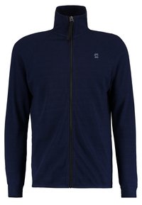 Giacca blu navy con zip e colletto alto, realizzata in un tessuto texturizzato. Presenta maniche raglan e un piccolo logo sul petto.