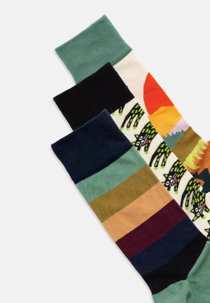 Tre par strumpor i olika färger: grön, svart, flerfärgade mönster. Har ribbade muddar, texturerad tyg och grafiska mönster.