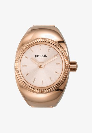 Montre bracelet Fossil en or rose avec cadran minimaliste, sans chiffres, et deux aiguilles indiquant 10h10, avec une lunette rainurée et une couronne à droite.