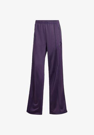 Un pantalon de sport violet, fabriqué en tissu lisse, se caractérise par une taille élastique, des poches latérales et une coupe ample avec des jambes droites.