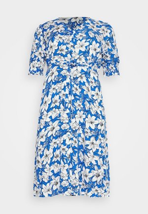 Abito floreale con sfondo blu, caratterizzato da gigli bianchi. Maniche corte, vita sfiancata e design al ginocchio. Tessuto leggero.